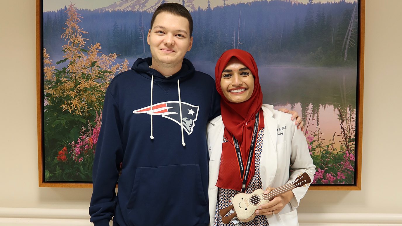 Alberto Diaz with Gohar Manzar, M.D., Ph.D., and the stuffed ukelele he presented to her