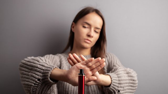 young woman rejecting a vape that is being offered her, and pushing back against the so-called benefits of nicotine