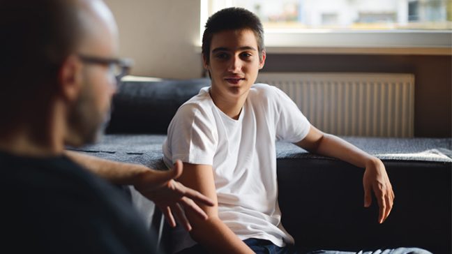 Teen is seen talking with older adult