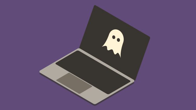 Gray and black laptop with a white ghost on the screen against a dark purple background.