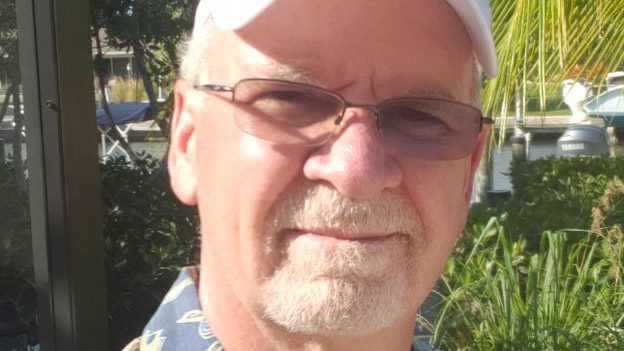 Man with gray facial hair wearing glasses