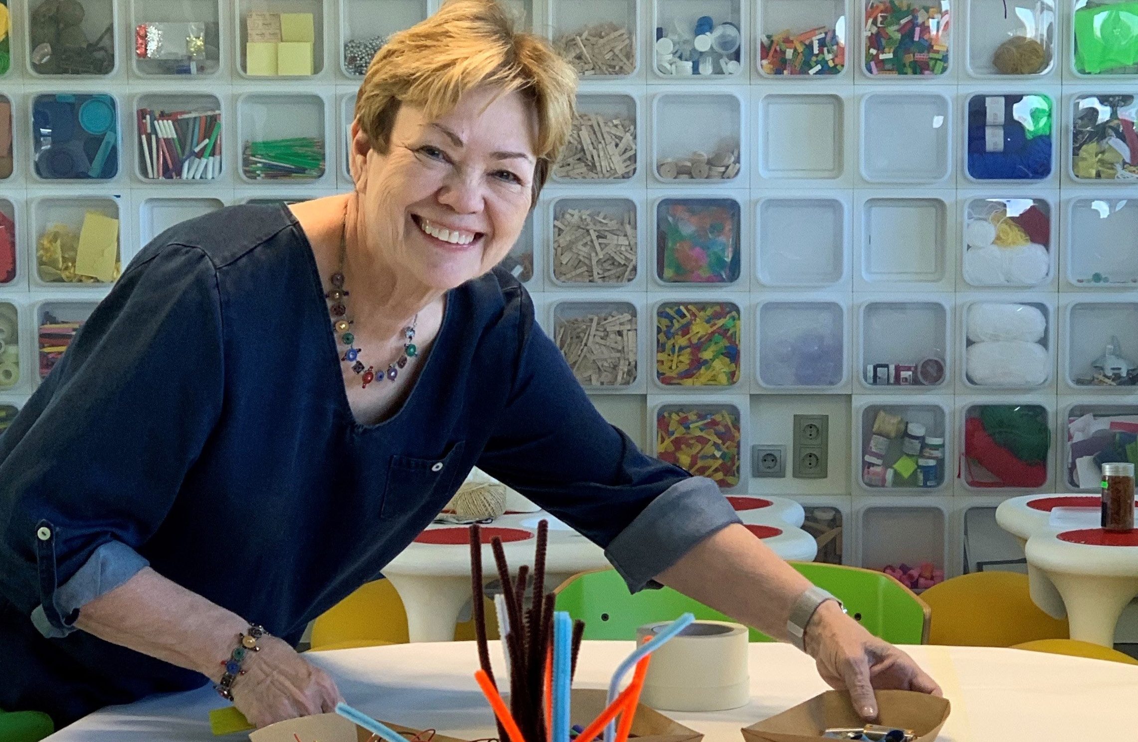 Cate in a classroom with arts and crafts