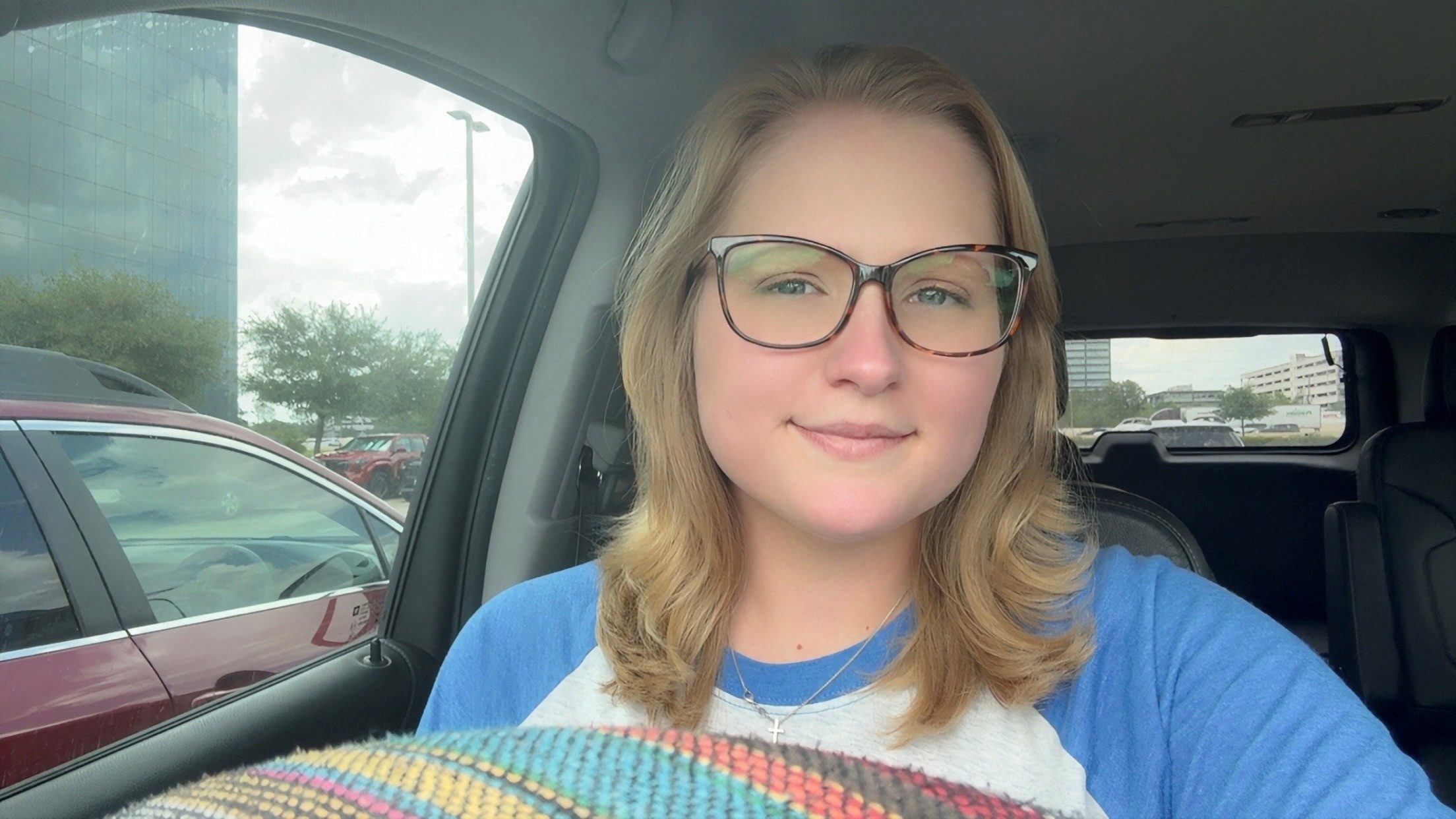 Young woman with blond hair wearing glasses