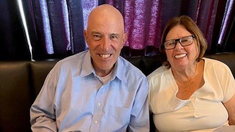 Man and woman sit next to each other in a booth
