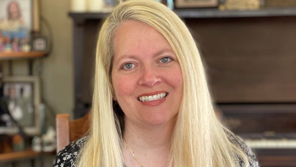 Smiling woman with long, blond hair