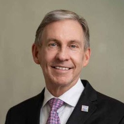 Peter WT Pisters, M.D.  - Man in black suit with pink and purple tie.