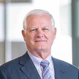 Man in black suit and purple tie.
