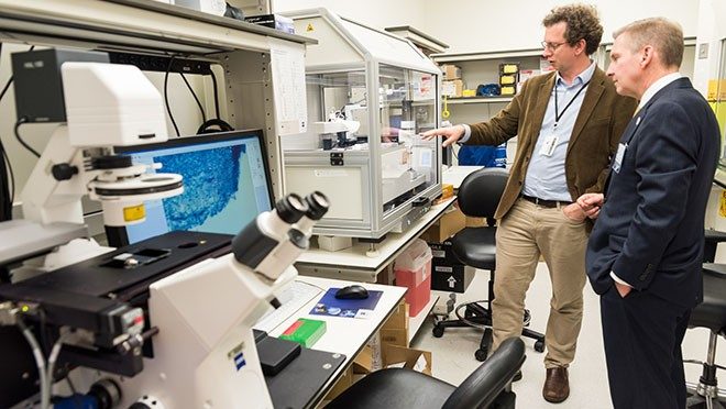 Peter Pisters tours a genetics laboratory
