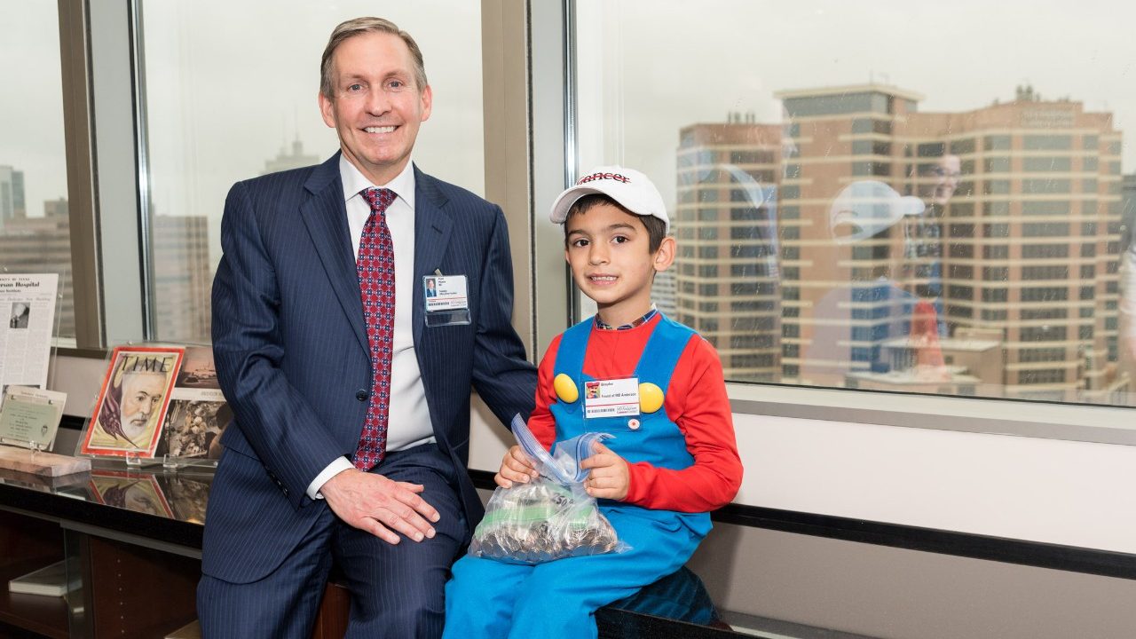 Cancerwise blog post: Brayden Rivera sits with Dr. Peter Pisters after raising money to help end cancer for patients like his mom, who has breast cancer