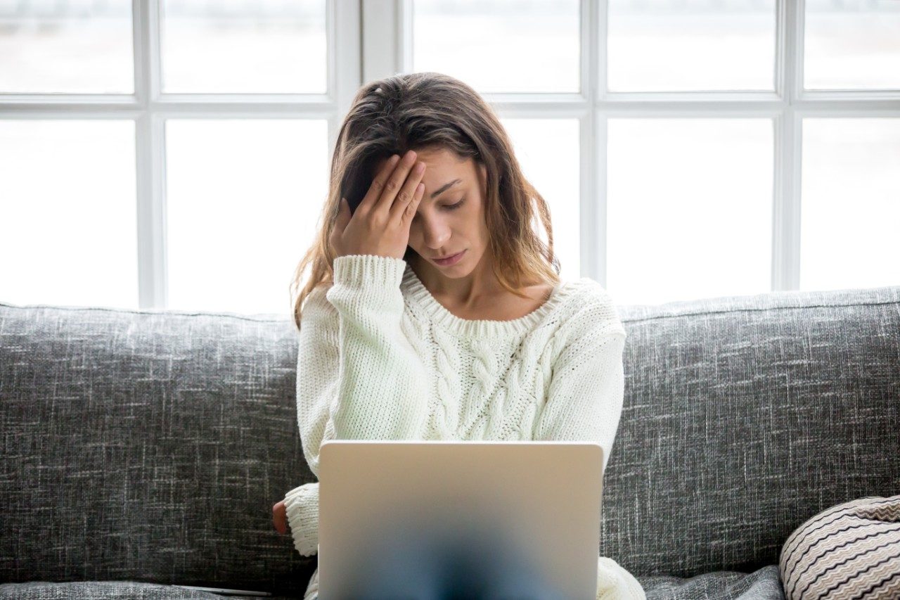 Anxious woman with laptop