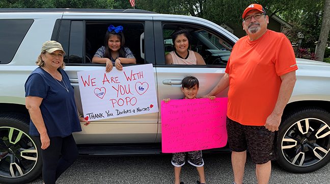 Robert’s wife, Linda; granddaughter, Gracyn; daughter, Alisa; grandson Gibo; and Robert pose with the signs.
