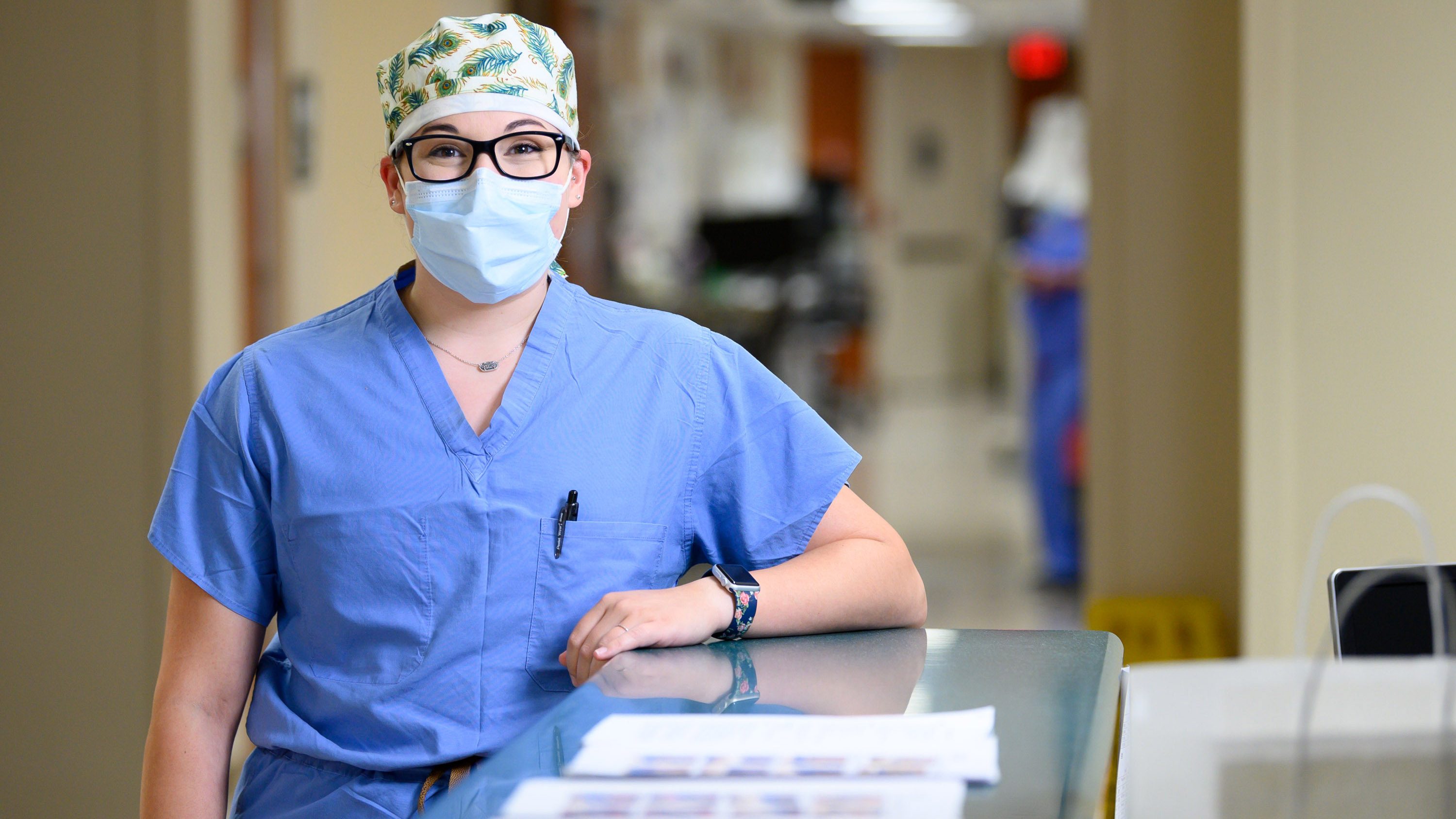 MD Anderson COVID-19 ICU nurse Brooke Spacek poses in the hallway, wearing a mask