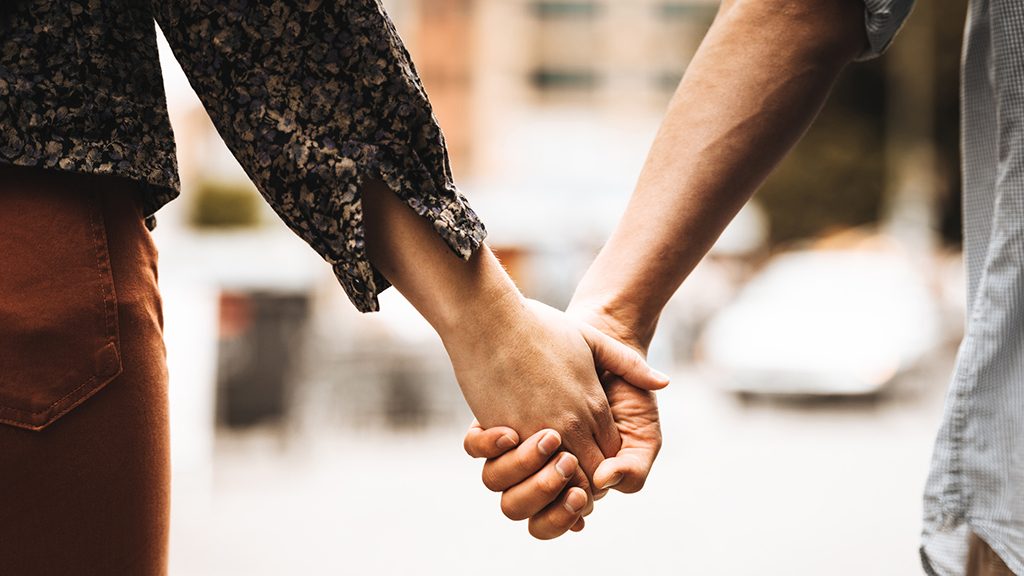 close-up photo of two people holding hands