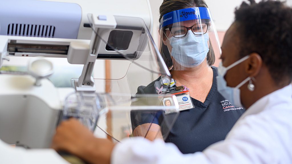 Mammography technician Ronna Cotton helps a mammogram patient at MD Anderson West Houston Diagnostic Imaging 