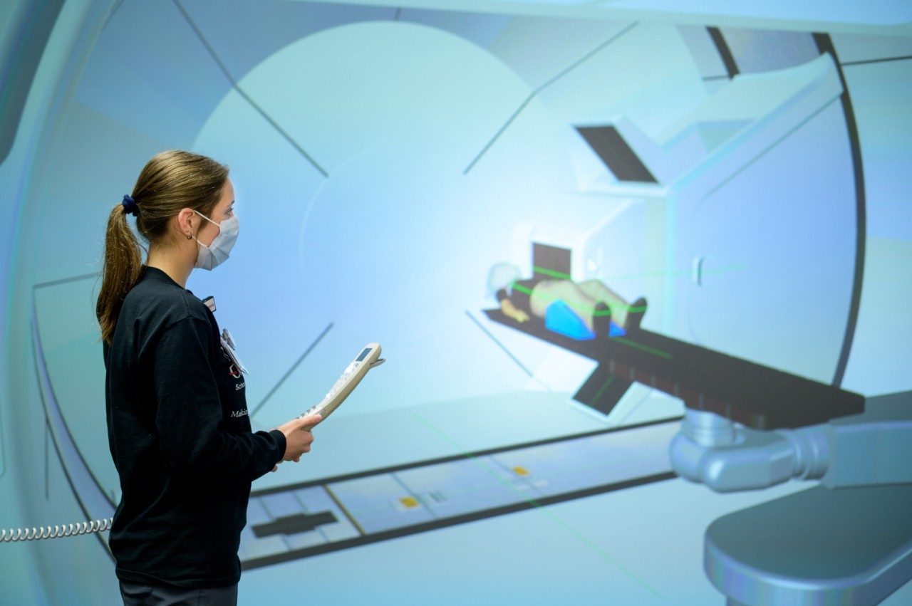 Radiation therapy student Jenna Casper practices delivering proton therapy to a simulated patient.