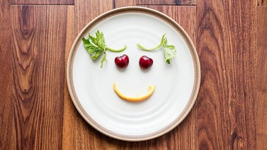 Plate with fresh food positioned to create a smiling face