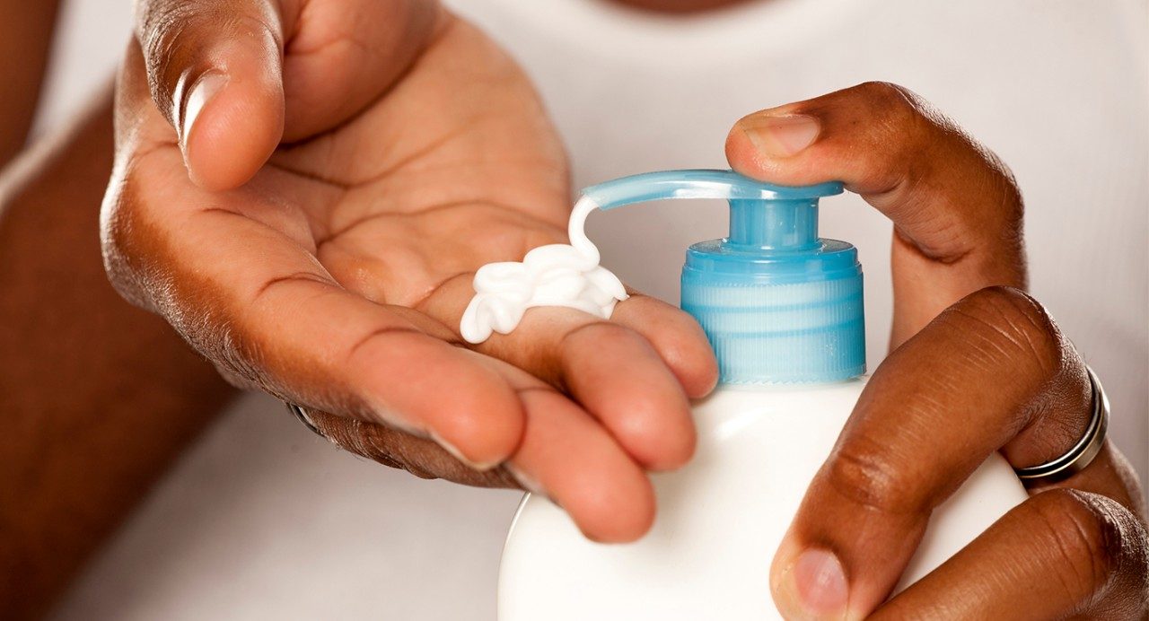 hands pumping lotion into palm