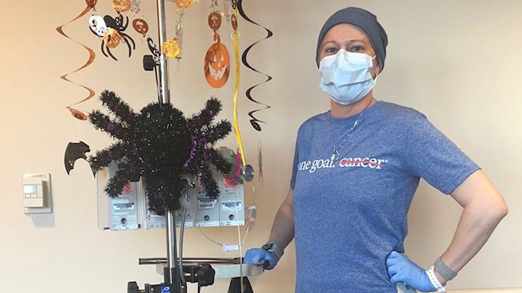 Multiple myeloma survivor Lindsay Crawford Suber, M.D., poses with her decorated chemotherapy pole in October 2018.