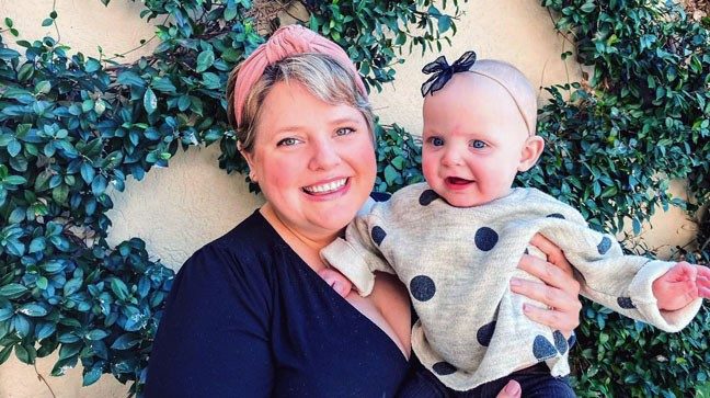 Betsy Lucas holding 10-month-old Aurelia