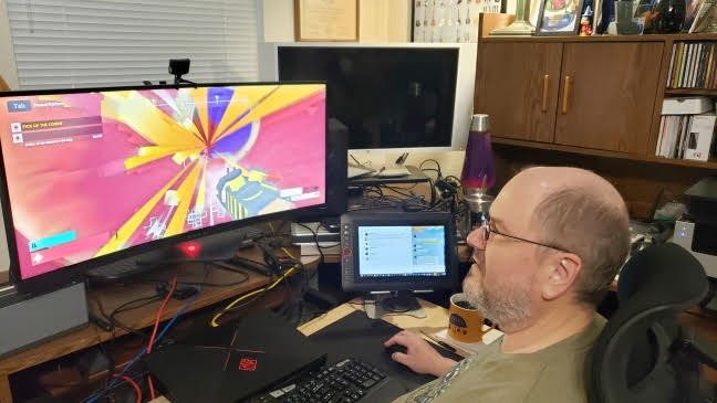 Photo of Jeff Blankenship playing the computer game he created