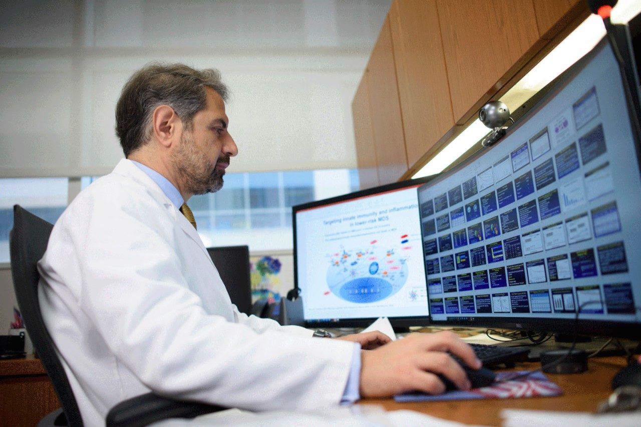 Photo of leukemia specialist Elias Jabbour, M.D., at his computer.