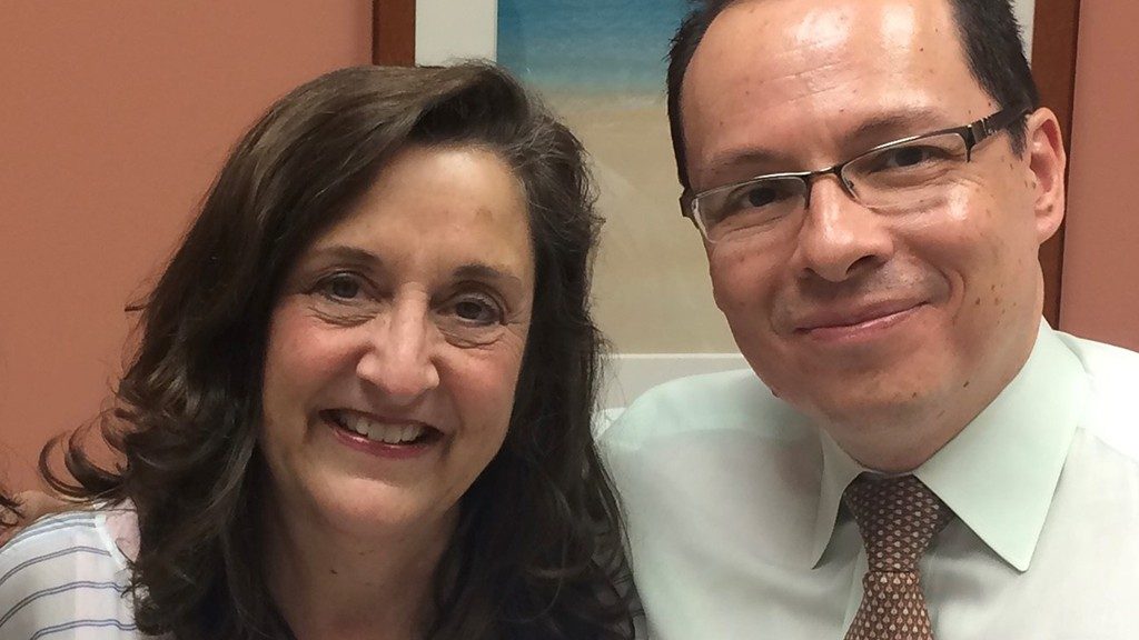 Pheochromocytoma survivor Susan Waldrop poses with her doctor, Camilo Jimenez, M.D., in the clinic during an appointment in July 2016.