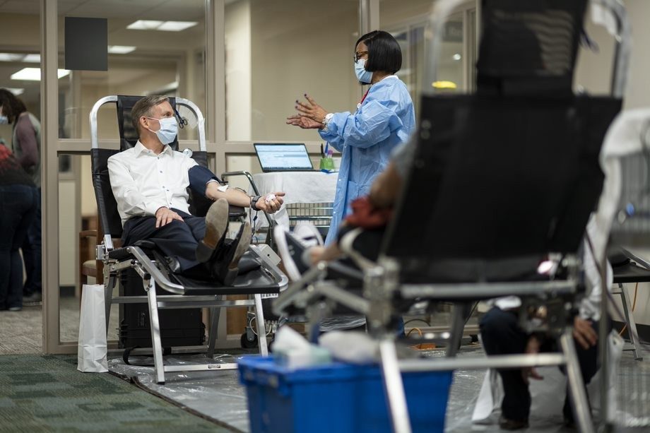 MD Anderson President Peter WT Pisters, M.D., speaks with senior blood donor technician Velisa Randle while he donates blood at MD Anderson Blood Bank.