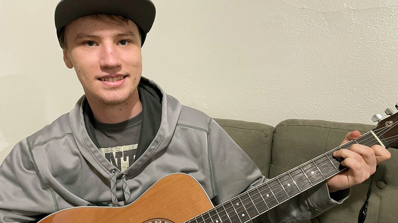 Arik Mayer playing his guitar