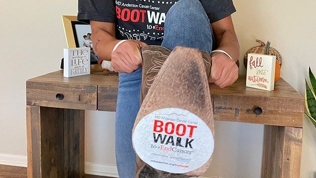 Breast cancer survivor Gretchen Lee Herrera shows off her boots