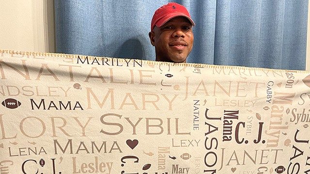 Throat cancer survivor Mark Teague poses with his blanket