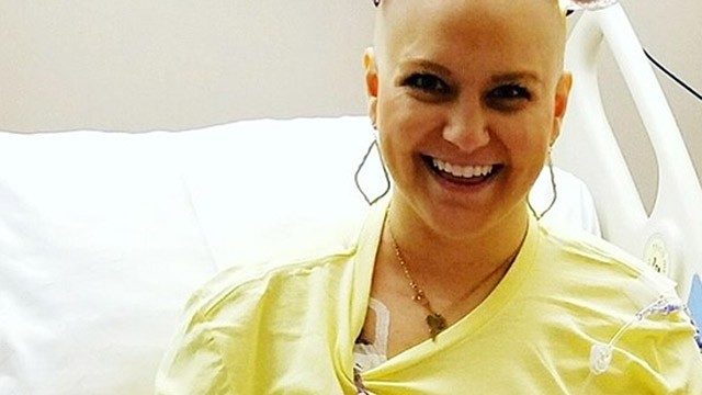 Sarcoma survivor Nicole Body wearing her "COURAGE" necklace