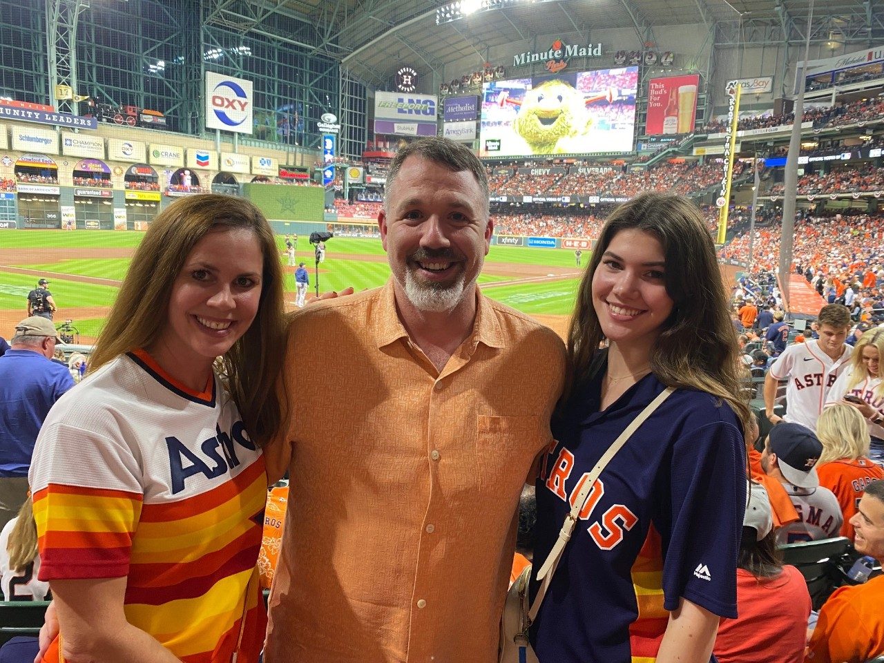 Kendall Levinthal embraces her parents, Angie and Jared Levinthal, at a baseball game.