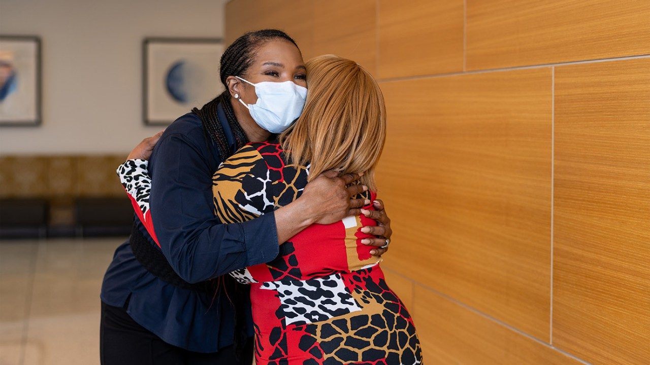 Fayleta Lawrence hugs a patient