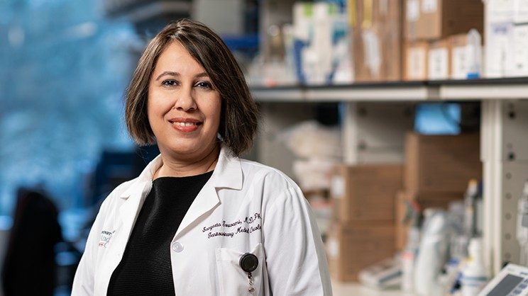 Sangeeta Goswami, M.D., Ph.D., stands in her lab