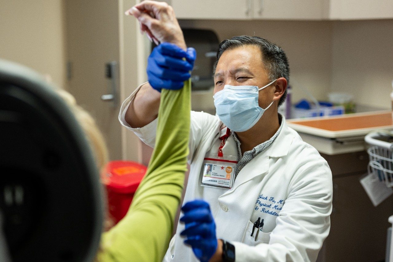 A picture of Dr. Jack Fu and a patient in the outpatient clinic