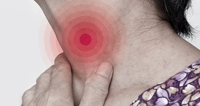 Close-up of woman touching her own neck