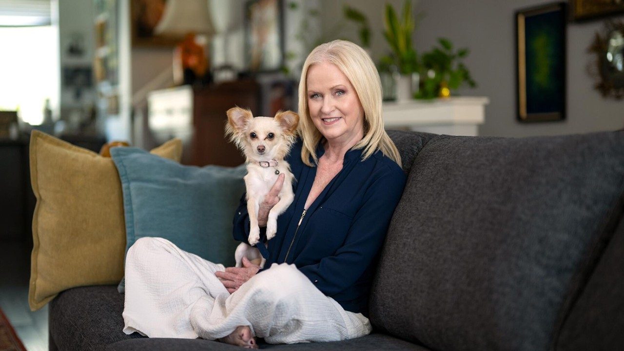 9-year melanoma survivor Colleen Wittoesch with her dog, Peony