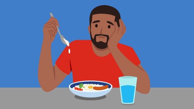 Graphic of man in red shirt frowning as he holds a spoon over a full plate with rice, an egg, sausage, a broccoli floret and a tomato slice.
