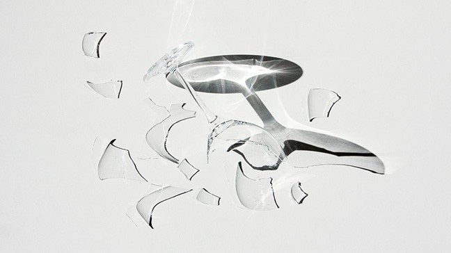 Broken wine glass on white surface