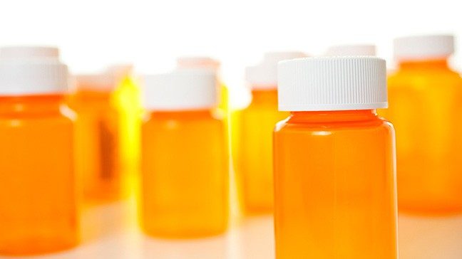 Orange pill bottles with white caps