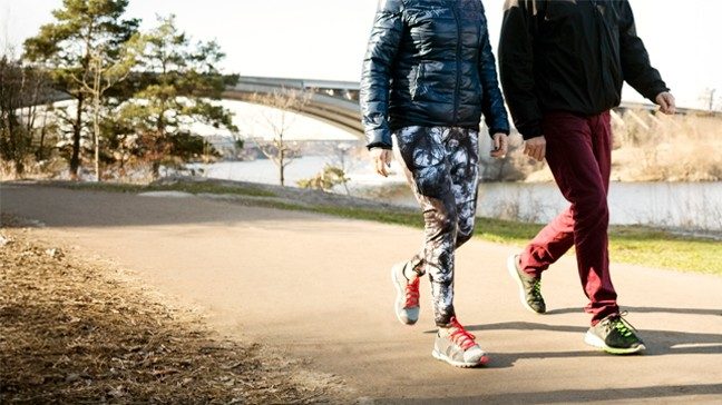 A man and a woman walking outside