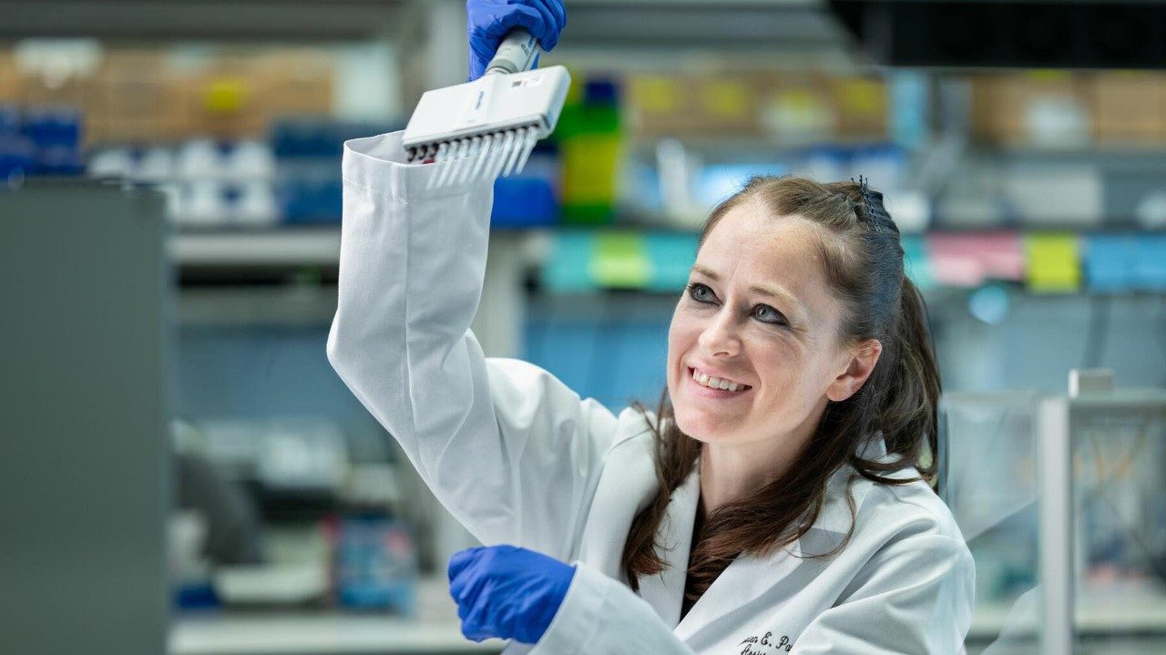 Woman wearing white lab coat 