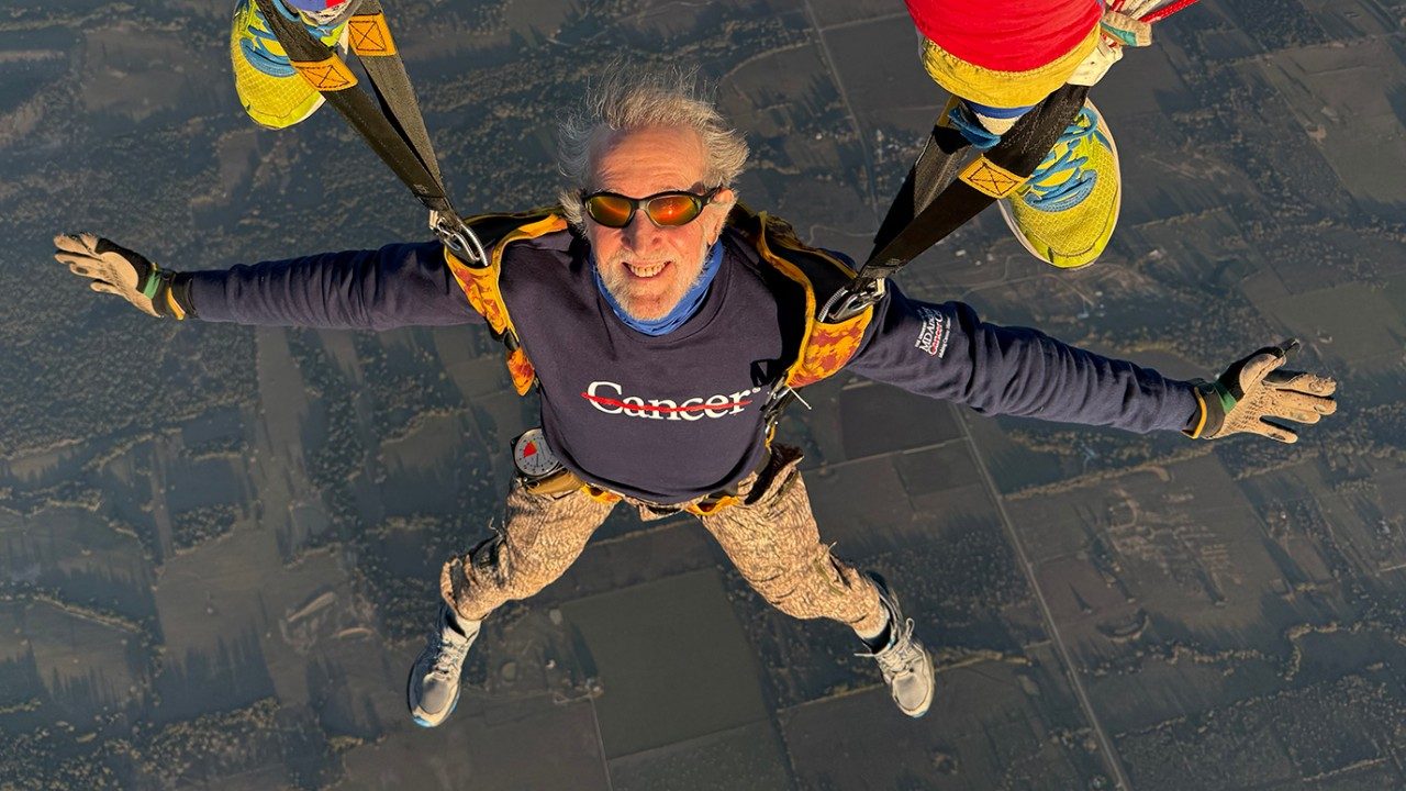 Veteran skydiver Walt Appel presented a photo like this one to every member of his MD Anderson care team in October 2025. The inscription read: “This is what being cancer-free for one year looks like. Thank you for being one of the heroes who made it happen.” 