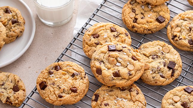 Fresh chocolate chip cookies cooling on a rack