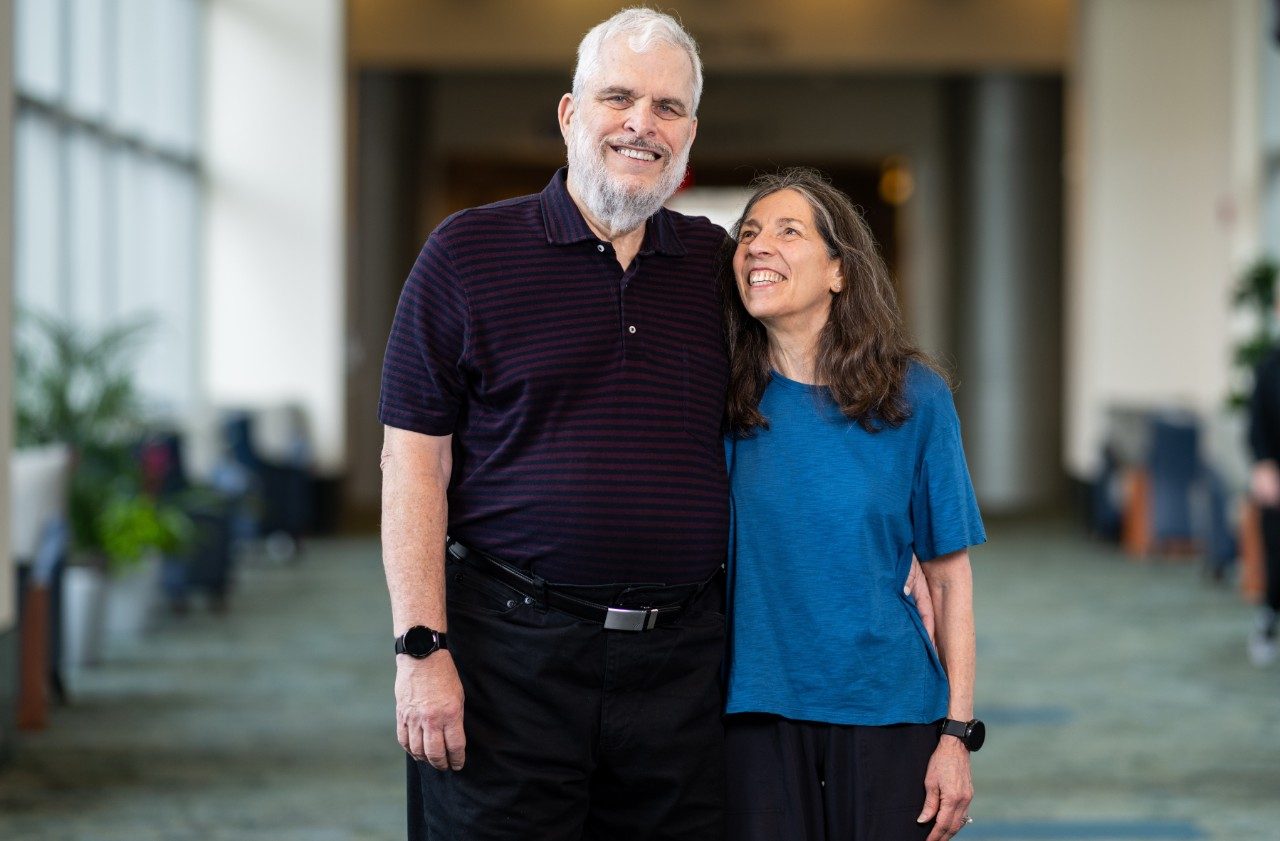 A man and woman stand side by side