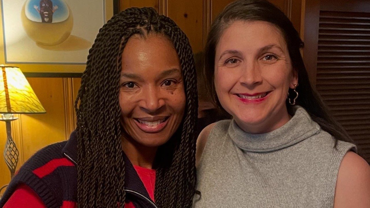 Myelodysplastic syndrome survivor Elle Crofton (right) with Terri Woodard, M.D. at Elle's baby shower in November 2025