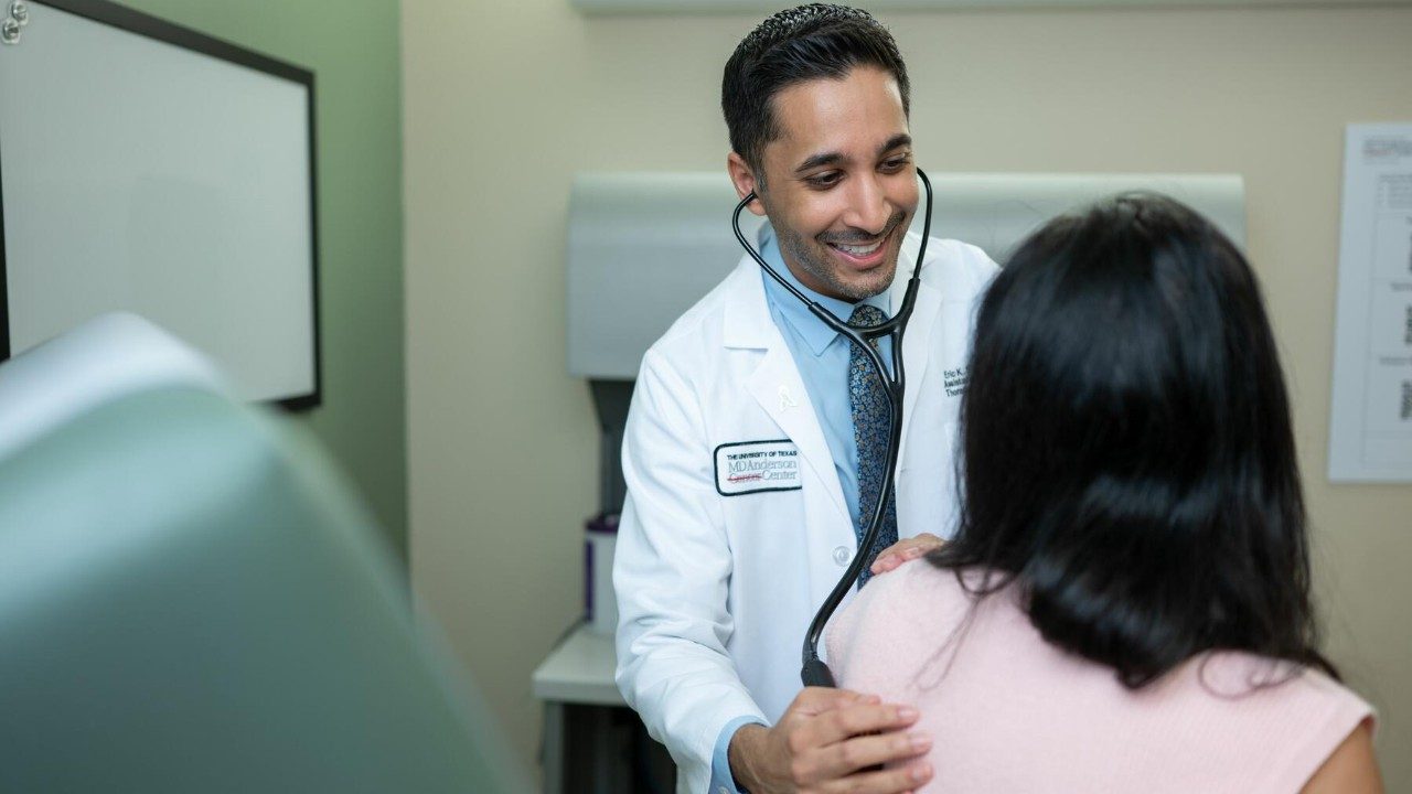 Doctor uses a stethoscope to perform an exam on a female patient