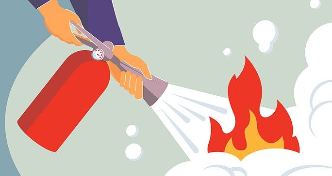 Hands holding a fire extinguisher douse flames