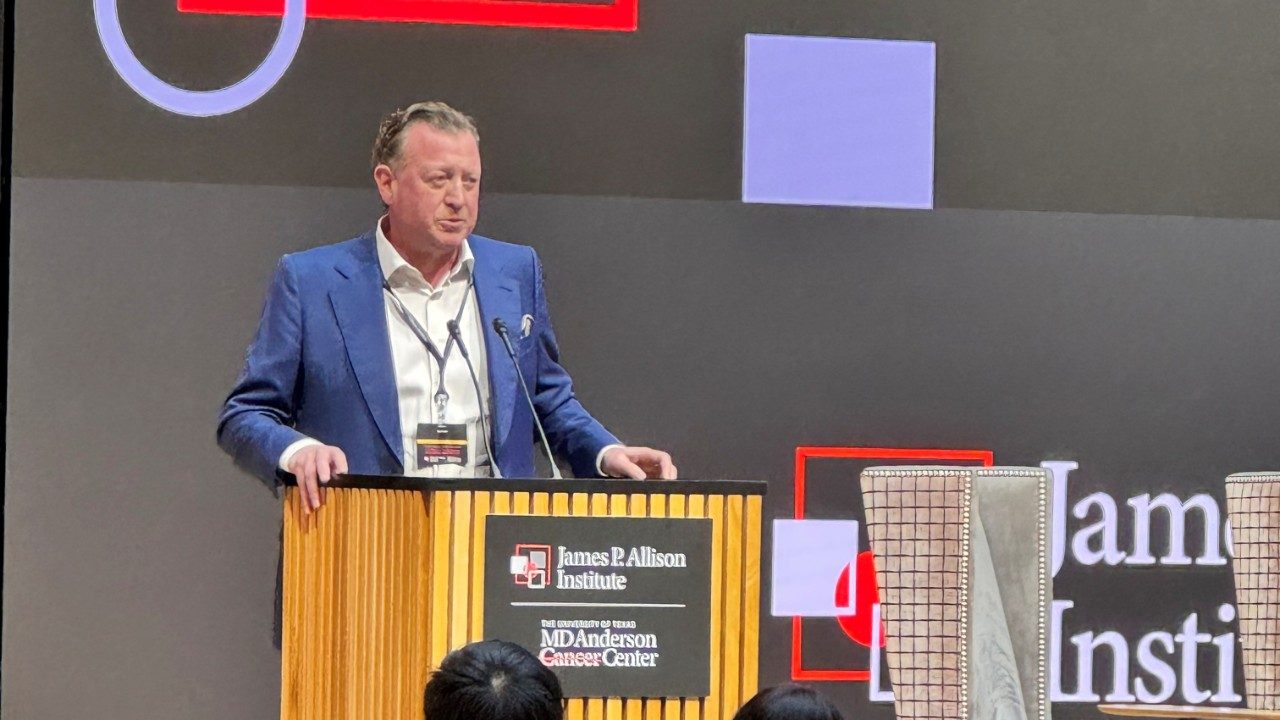 Man stands in front of podium