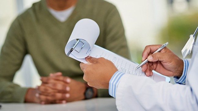 Unidentified man discussing test results with unidentified doctor